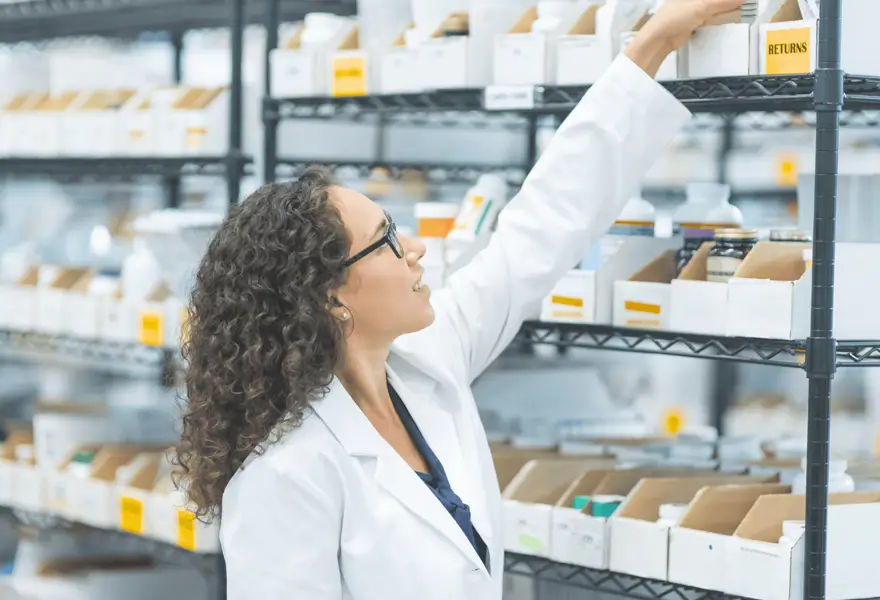 Pharmacist placing products on shelves